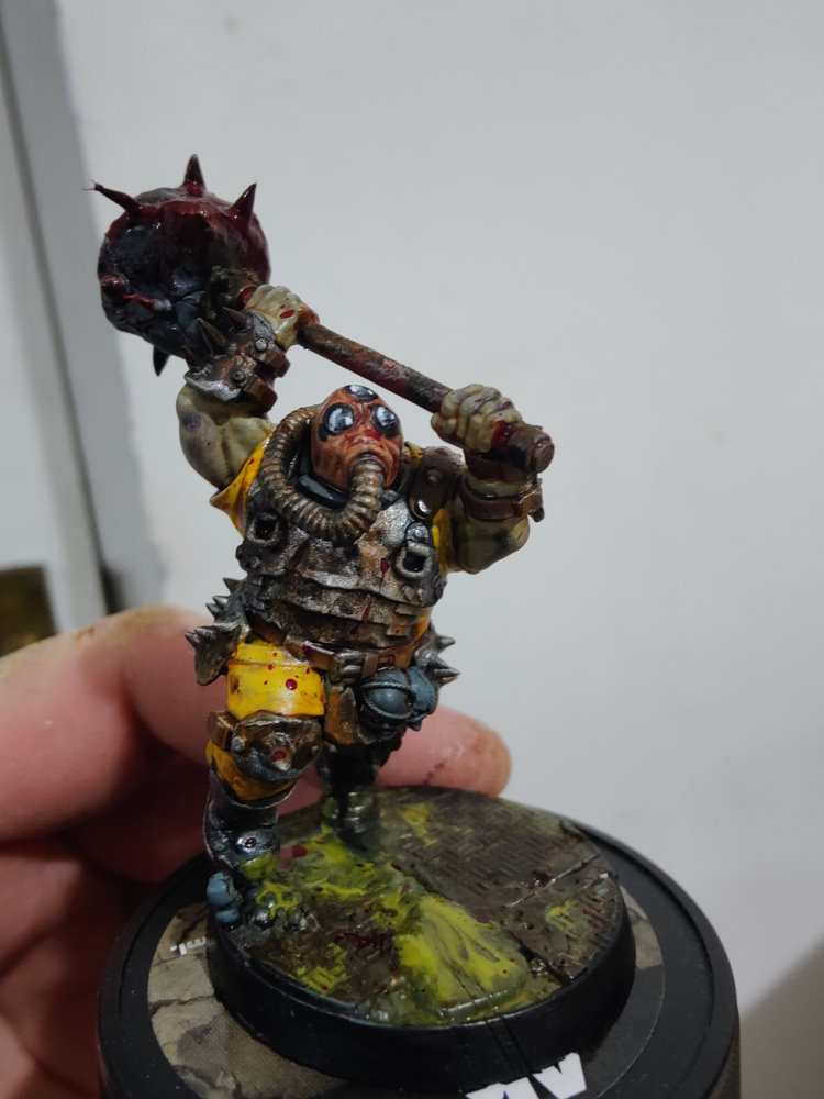 Filip holding a freshly painted tabletop miniature