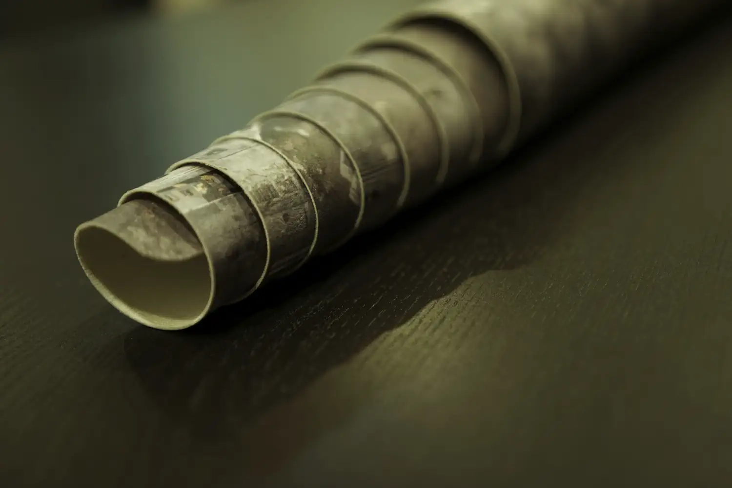 A 2D6 roll-up Gaming Mat prepared for storage